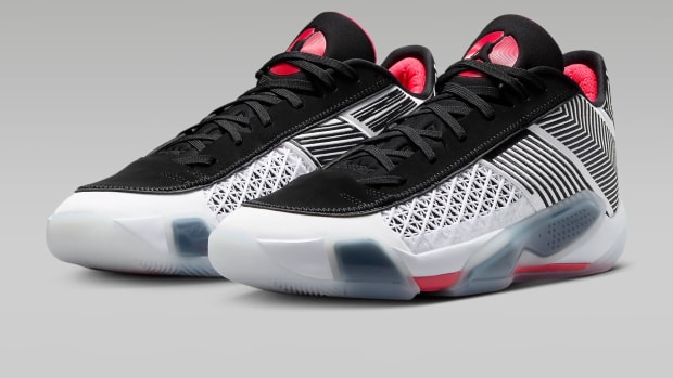 Side view of white, black, and red Air Jordan sneakers.